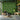 Modern living room with artificial green plant wall backdrop, UK contemporary home decor.