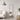 In a modern living room, a black-framed rectangular full-length mirror hangs on a light gray wall, beside a beige sofa and a small side table, showcasing a minimalist and stylish design
