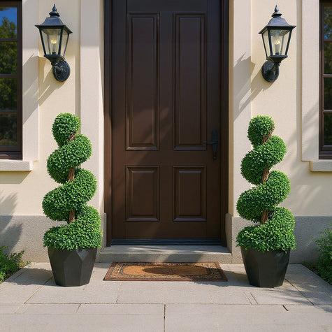 Artificial potted plants with upward spiraling growth on both sides of the entrance, creating a natural and fresh foyer atmosphere
