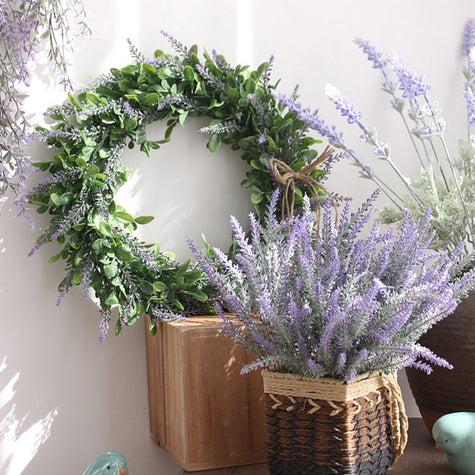 Artificial green leaf and lavender wreath on wooden crate with basket of faux lavender, UK rustic home decor.