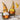Two Autumn Harvest Gnome figurines holding pumpkins standing in a row.