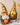 Two Autumn Harvest Gnome figurines holding pumpkins standing in a row.