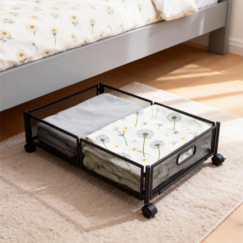 Under-bed storage box with metal frame and caster wheels next to the bed and nightstand in a modern bedroom, easy to move and access