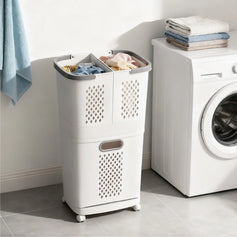 Two multi-tier laundry baskets with shelves on top, one with two baskets and one with three, against a green background.