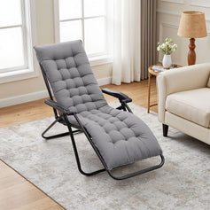 Lazy lounge chair positioned in the center of the living room’s gray carpet, with a light gray rectangular cushion tied on, offering comfort and relaxation