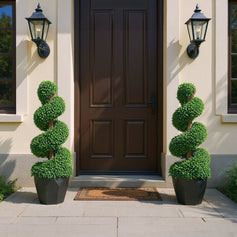 Artificial potted plants with upward spiraling growth on both sides of the entrance, creating a natural and fresh foyer atmosphere